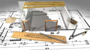 Un plan et une maquette de maison en construction